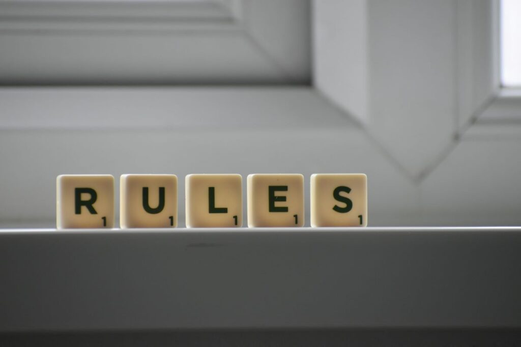 Cubes with rules inscription showing gaps in between depicting the unseen problem with rules 